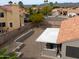 Aerial view of the backyard with a covered patio and gravel landscaping with desert plants at 15018 S 28Th St, Phoenix, AZ 85048