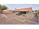 A well-maintained backyard boasts gravel landscaping and a covered patio with comfortable seating at 15018 S 28Th St, Phoenix, AZ 85048