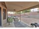 Relaxing backyard featuring a covered patio with stylish seating, plants, and a decorative desert landscape at 15018 S 28Th St, Phoenix, AZ 85048