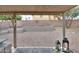 Covered patio looks out on a well-maintained backyard featuring decorative rock and mature landscaping at 15018 S 28Th St, Phoenix, AZ 85048