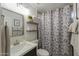 Bathroom featuring modern vanity, framed mirror, decorative shower curtain and tiled accents at 15018 S 28Th St, Phoenix, AZ 85048