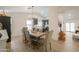 Dining room featuring a rustic wooden table, upholstered chairs, and an open floor plan at 15018 S 28Th St, Phoenix, AZ 85048