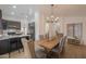 Dining room featuring a rustic wooden table, upholstered chairs, and open layout to the kitchen at 15018 S 28Th St, Phoenix, AZ 85048