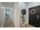 Bright entryway featuring a modern black front door, white walls and wood-look flooring at 15018 S 28Th St, Phoenix, AZ 85048