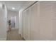 Hallway with wood-look floors, bi-fold closet doors and access to rooms beyond at 15018 S 28Th St, Phoenix, AZ 85048