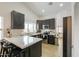 Modern kitchen featuring dark cabinets, stainless steel appliances, and bar seating at 15018 S 28Th St, Phoenix, AZ 85048