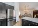 Contemporary kitchen featuring dark cabinets, stainless steel refrigerator, and open layout at 15018 S 28Th St, Phoenix, AZ 85048