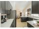 Contemporary kitchen featuring dark cabinets, stainless steel appliances, and bright white countertops at 15018 S 28Th St, Phoenix, AZ 85048
