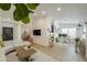 Bright living room featuring an L-shaped couch, wood coffee table, and open layout to an office space at 15018 S 28Th St, Phoenix, AZ 85048