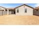 Rear exterior of home featuring a covered patio and a large backyard, ready for landscaping at 17057 W Seldon Ln, Waddell, AZ 85355