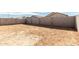 Large dirt backyard ready for customization with block wall, offering privacy for outdoor enjoyment at 17057 W Seldon Ln, Waddell, AZ 85355