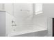 A bathroom featuring a soaking tub surrounded by bright white walls and a chrome faucet at 17057 W Seldon Ln, Waddell, AZ 85355