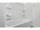 Bright bathtub and shower combination with white tile and a rainfall shower head at 17057 W Seldon Ln, Waddell, AZ 85355