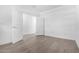 Bright bedroom with light colored wood-look flooring, white walls, white doors and a window at 17057 W Seldon Ln, Waddell, AZ 85355