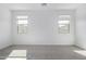 Bright bedroom with plush carpet, large windows providing natural light and neutral walls ready for decor at 17057 W Seldon Ln, Waddell, AZ 85355