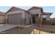 Charming single-story home featuring a two-car garage, low maintenance landscaping and neutral color palette at 17057 W Seldon Ln, Waddell, AZ 85355