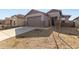 Charming single-story home featuring a two-car garage, low maintenance landscaping and neutral color palette at 17057 W Seldon Ln, Waddell, AZ 85355