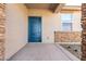 Blue front door with glass and stone accents at 17057 W Seldon Ln, Waddell, AZ 85355