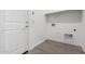 Laundry room with tile flooring, white walls, and in-wall hookups for a washer and dryer at 17057 W Seldon Ln, Waddell, AZ 85355