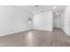 Bright living room with light colored wood-look flooring, white walls, and a window at 17057 W Seldon Ln, Waddell, AZ 85355