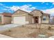 Exterior view of home with desert landscaping, red door and 2 car garage at 17081 W Seldon Ln, Waddell, AZ 85355