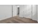 Hallway featuring neutral carpet, white walls, and doors that offer access to different rooms at 17081 W Seldon Ln, Waddell, AZ 85355