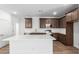 Modern kitchen with quartz countertops, a breakfast bar, and stainless steel appliances at 17081 W Seldon Ln, Waddell, AZ 85355