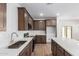 This modern kitchen features quartz countertops, stylish backsplash, and dark wood cabinets at 17081 W Seldon Ln, Waddell, AZ 85355