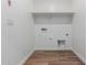 A simple laundry room with a shelf, tile floor, and washer/dryer hookups at 17081 W Seldon Ln, Waddell, AZ 85355