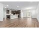 Open-concept living space with wood-look tile floors, a kitchen island, and stylish lighting at 17081 W Seldon Ln, Waddell, AZ 85355