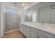 Modern bathroom featuring double sinks, a large mirror, and glass shower at 17313 W Via Dona Rd, Surprise, AZ 85387