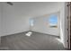 Sunny bedroom with neutral carpet, white walls, and scenic window views at 17313 W Via Dona Rd, Surprise, AZ 85387