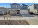 Charming two-story home with a two-car garage and neutral colored exterior at 17313 W Via Dona Rd, Surprise, AZ 85387