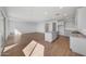Open-concept kitchen with granite countertops, stainless steel appliances, and wood-look tile flooring at 17313 W Via Dona Rd, Surprise, AZ 85387