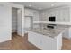 Bright kitchen with white cabinets, an island, and stainless steel appliances at 17313 W Via Dona Rd, Surprise, AZ 85387