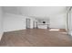 Open-concept living room with white walls and wood-look tile at 17313 W Via Dona Rd, Surprise, AZ 85387