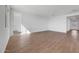 Large living room with wood-look floors and white walls at 17313 W Via Dona Rd, Surprise, AZ 85387