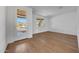 Living room with wood floors and a window to the right of the front door at 17313 W Via Dona Rd, Surprise, AZ 85387