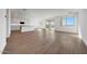 Open living space with sliding glass doors and an attached kitchen with white cabinetry at 17313 W Via Dona Rd, Surprise, AZ 85387