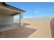 A spacious backyard features a covered patio, a concrete slab, and views of the perimeter block wall at 17322 W Via Dona Rd, Surprise, AZ 85387