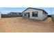 A view of the home's backyard including the covered patio, multiple windows, and privacy fencing at 17322 W Via Dona Rd, Surprise, AZ 85387