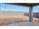View of the backyard showing a blank canvas of dirt and concrete patio at 17322 W Via Dona Rd, Surprise, AZ 85387