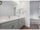 Bright bathroom with double sinks, quartz countertops, and a view of a bedroom at 17322 W Via Dona Rd, Surprise, AZ 85387