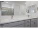 Bright bathroom with double vanity, quartz countertops, and glass-enclosed shower at 17322 W Via Dona Rd, Surprise, AZ 85387