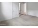 Bedroom showcasing neutral carpet, with doors to the closet and bathroom at 17322 W Via Dona Rd, Surprise, AZ 85387