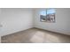 Bedroom with carpet, a large window, and view of a residential neighborhood at 17322 W Via Dona Rd, Surprise, AZ 85387