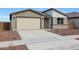 Charming single-story home featuring a two car garage and low maintenance desert landscaping at 17322 W Via Dona Rd, Surprise, AZ 85387