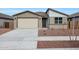 Charming single-story home featuring a two car garage and low maintenance desert landscaping at 17322 W Via Dona Rd, Surprise, AZ 85387
