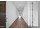 Hallway with wood-style floors and recessed lighting leading to an open space at 17322 W Via Dona Rd, Surprise, AZ 85387
