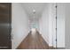 Hallway with hardwood-style floors, recessed lighting, and a view to the backyard at 17322 W Via Dona Rd, Surprise, AZ 85387